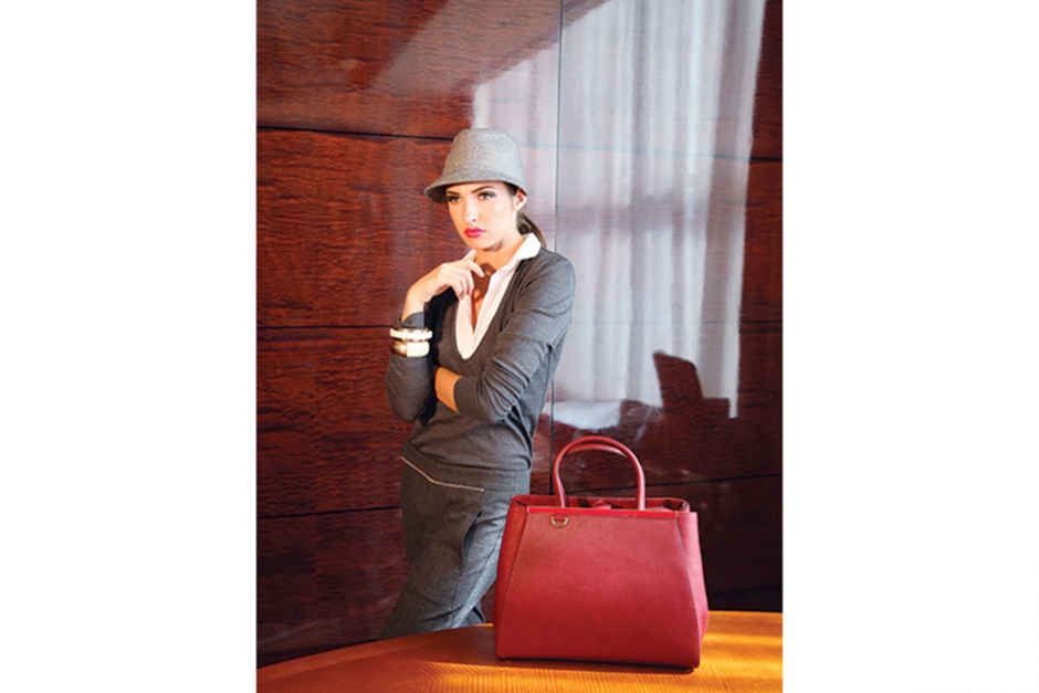 The Power Purse
Conquer the boardroom in Cucinelli with luxurious trousers, $775, and an ultra-soft sweater, $995, and hat, $330, plus Fendi’s knock-out bag, $2,260, and Marni bangles, $350 and $420.