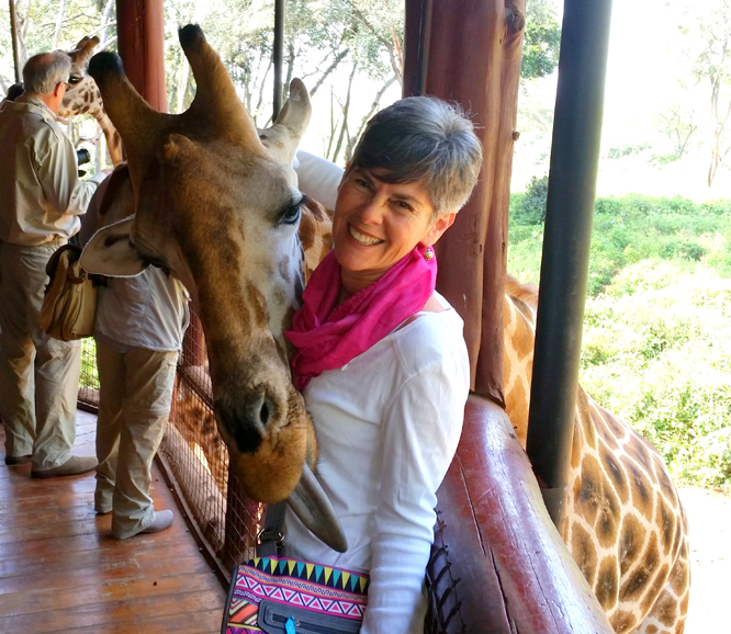 Christine Negroni feeding an endangered Rothschild giraffe at the Giraffe Center in Karen, Kenya, named for writer Karen Blixen.