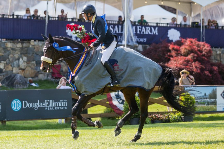 Olympic gold medalist Leslie Howard takes the victory gallop aboard Quadam, owned by Laure Sudreau, after winning the $133,700 CSI 3* Grand Prix, presented by The Kincade Group during Old Salem Farm's Spring Horse Shows in 2019. Photograph by Jump Media.