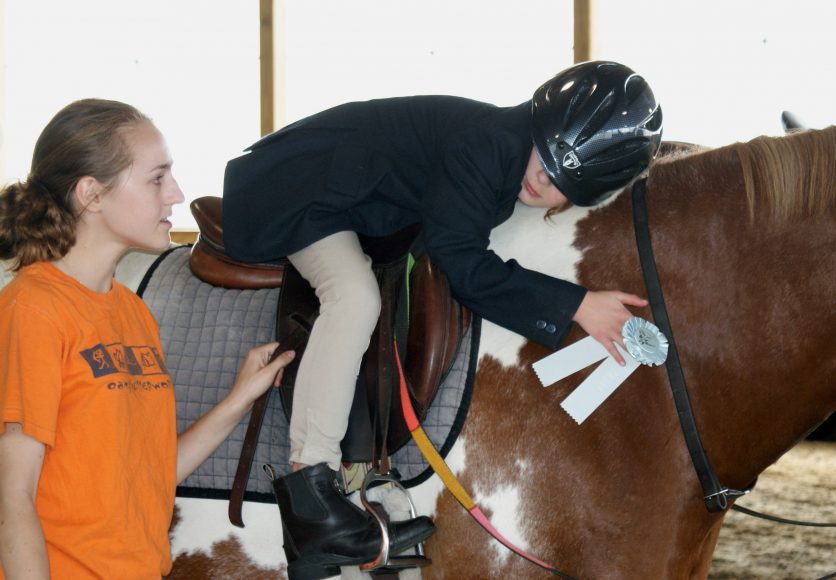 A child embraces a horse at Pegasus Therapeutic Riding in Brewster. Photograph courtesy of Pegasus Therapeutic Riding.