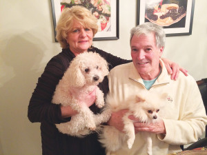 Jackie Ruby, “The Cooking Realtor” featured in WAG’s February issue, and her husband, Doug, with their dogs. Jackie holds Diva, a Bichon Frise, while her husband has Valentino, a white teacup Pomeranian, in hand. 
