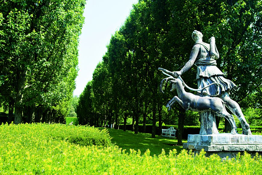 A statue of Diana, the Roman goddess of the hunt protects the pear trees in the gardens of Brook Hill Farm, Oscar de la Renta’s Kent, Conn., home. From “Oscar de la Renta:  The Style, Inspiration, and Life of Oscar de la Renta.” Copyright Oscar de la Renta Archives. Courtesy Assouline