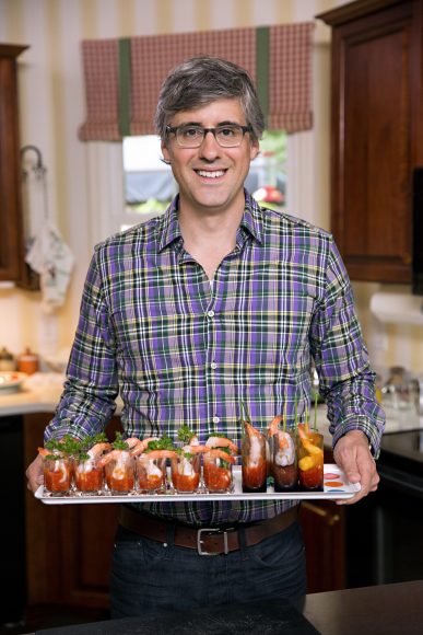 Host Mo Rocca poses with the Shrimp Cocktail Shooters he made with Ilene and Freddie Tsuhara , as seen on Cooking Channel’s My Grandmother’s Ravioli, Season 2.