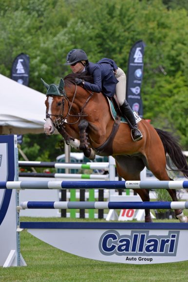Starbuck Equestrian goes over the Callari Auto Group sponsored jump at the 83rd annual Charity Horse Show last June. Photograph courtesy Ox Ridge Hunt Club.