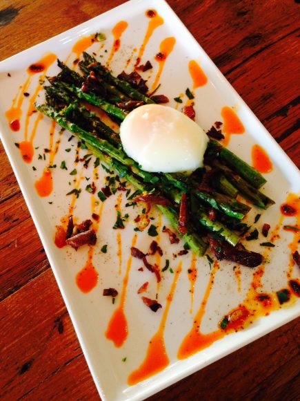 Sugar & Olives skillet asparagus with a duck egg, pork belly and ramps.