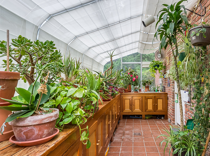 High tech upgrades like temperature control and powered shades make indoor gardening a breeze in this Greenwich greenhouse. Courtesy Houlihan Lawrence.