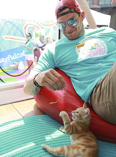 Frisks® teams up with pro football punter Steve Weatherford to help shelter cats find forever homes at the "Friskies Playhouse," an interactive adoption event to launch Pull 'n Play™.  Photograph by Amy Sussman/AP Images for Friskies.