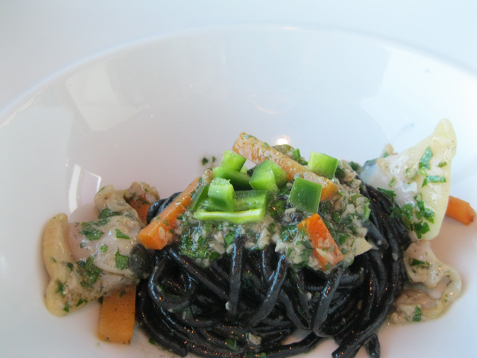 Squid ink spaghetti in white clam sauce with carrots and pickled jalapeño.