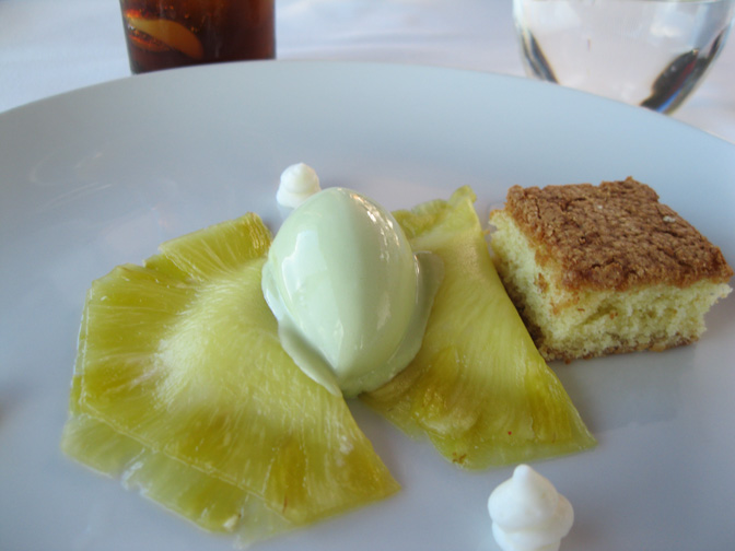 Pineapple ravioli stuffed with yogurt and yuzu mousse and served with mint ice cream and an olive oil cake.