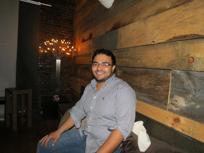 Alex Zuluaga sits in the lounge area in the back of Infusion.