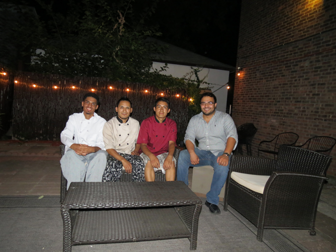 From left, chefs Gustavo Coronado, Reynaldo Jesus, Elvis Sarita sit with Alex Zuluaga in the outdoor lounge area. 