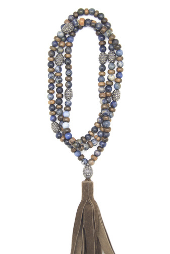 A necklace of Dumortierite beads and wood rondelles mixed with rhinestones in a wrap style with a brown suede tassel.