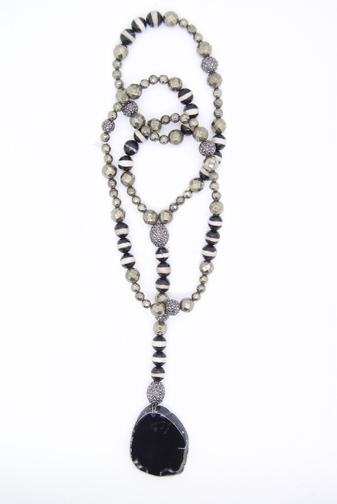 A necklace of pyrite, agate and Tibetan zebra-like beads mixed with rhinestones in a lariat-style with a sliced agate pendant.