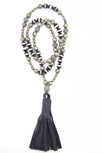A necklace of pyrite, agate and Tibetan zebra-like beads mixed with rhinestones in a lariat-style with a leather tassel.