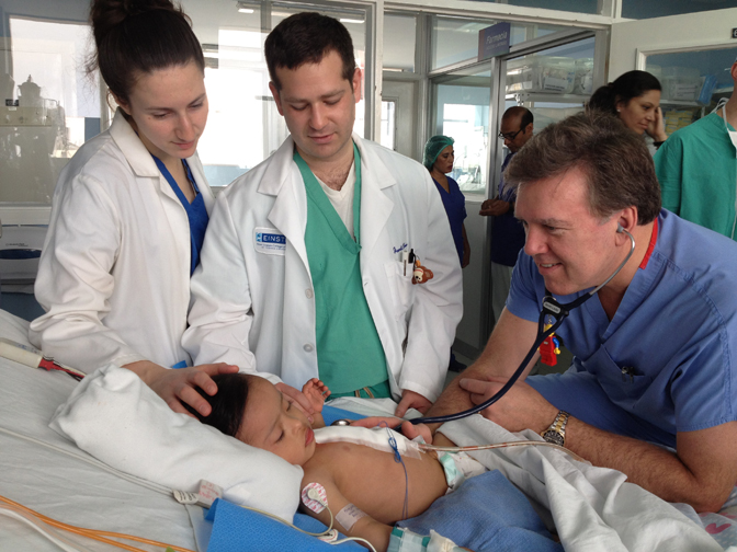 Robert Michler is teaching medical students at the bedside. Photograph courtesy HeartCare International.