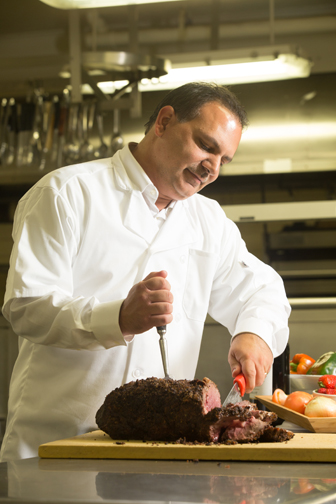 Al Ciuffetelli carves prime rib, a specialty of Homestyle Caterers. Photograph by John Rizzo.