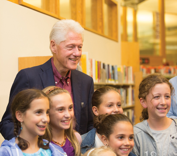 Former President Bill Clinton with some of Chelsea Clinton's young fans. Photograph by John Rizzo. 