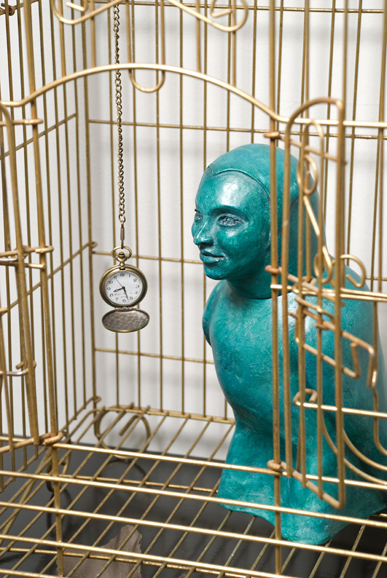 “Aviary 10: Gold Watch,” pigmented cast stone, metal cage, pocket watch, clay. Photograph by Howard Goodman, courtesy of the artist, Sarah Haviland.