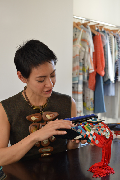Bea Valdes, sporting a favorite BEAVALDES necklace, explains the intricate work that goes into one of her company’s beaded bags. Photograph by Bob Rozycki.