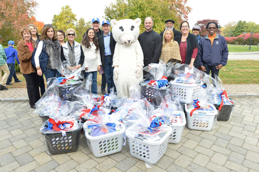 Adult supporters of the Make a Difference With Loukoumi Project, along with the Loukoumi mascot.