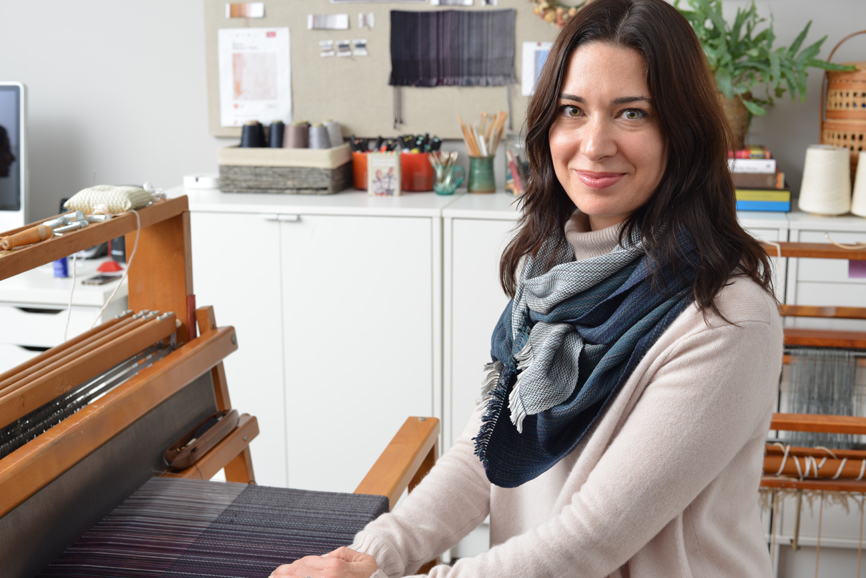 Kavulla models one of her handmade scarves in her workshop. Photograph by Bob Rozycki.