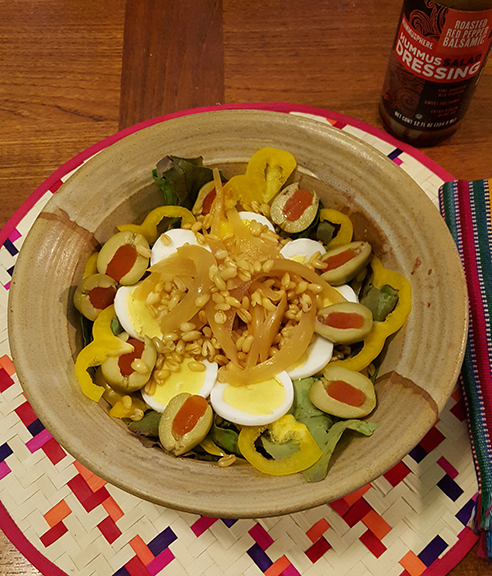 Hummusphere Foods’ Roasted Red Pepper Balsamic Hummus Dressing adds a final touch to this inviting salad. Photograph courtesy of Hummusphere