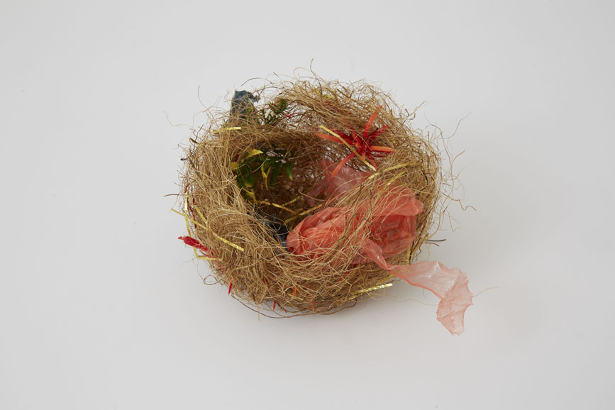 Björn Braun's "Untitled (zebra finch’s nest)," (2015), coconut fiber, plastic bag, silver tinsel, golden tinsel, and artificial plastic plants, 4 ½ x 7 x 6 inches. Courtesy of the artist and Marianne Boesky Gallery. 