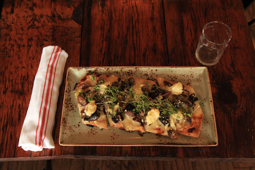 Truffle flatbread with roasted mushrooms and cheese. Photograph by Danielle Brody.