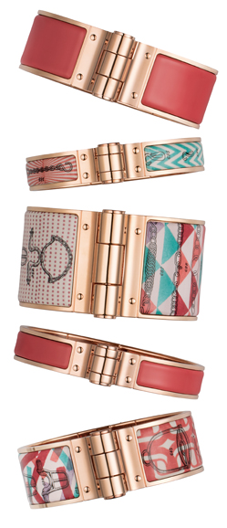Bracelets in enamel, inspired by the “Balades Équestres” scarf, $830, $660 and $600
Linked by a large hinge inspired by travel trunks, the clasp of these bracelets is hidden by a saddle tack that activates the mechanism. The motifs show the straps and ropes in the “Balades Équestres” scarf, with a design by Henri d’Origny. The bracelets are available in three sizes – thin, large and extra-large. Photograph courtesy of Hermès.