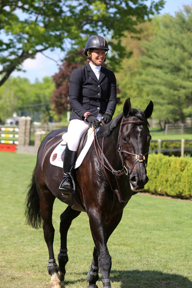 Beezie Madden is all smiles after a clear round with Cortes C on the Grand Prix Field at Old Salem Farm. Photograph by Lindsay Brock for Jump Media.