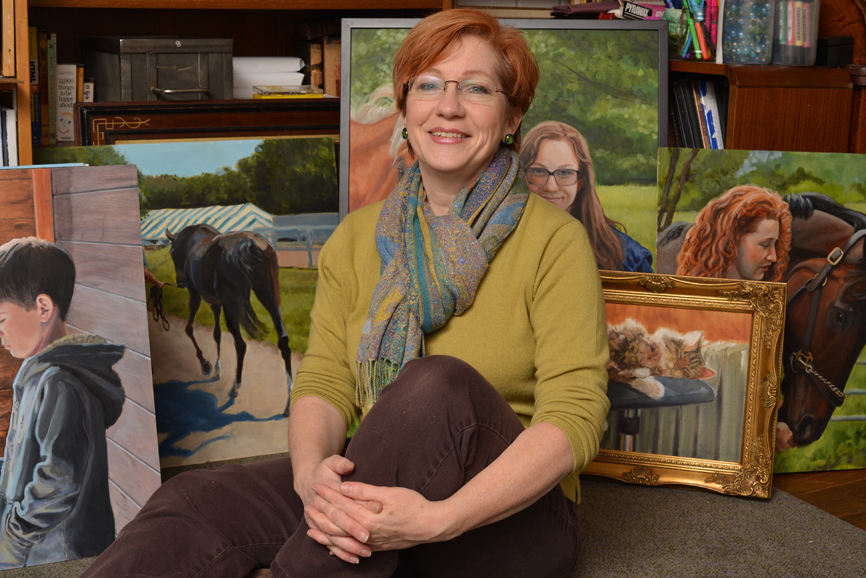 Gini Fischer, with an assortment of her paintings. Photograph by Bob Rozycki.