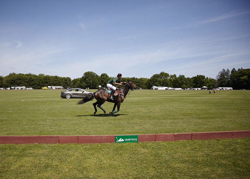 June 7, 2015 marked Greenwich Polo Club's 34th season opener. It was a day to remember with a never-before horsepower showdown between Tesla Motors and polo pony Picolina ridden by Joaquin Panelo. Photograph by Katerina Morgan. Photograph courtesy Greenwich Polo Club.