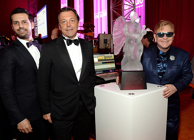 Maz Zouhairi, CEO of Lalique North America, and Silvio Denz, chairman and CEO of Lalique, from left, join Elton John at his Academy Awards party in Los Angeles. Photograph courtesy Lalique.