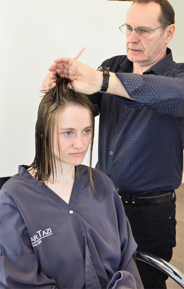 Toohey freshens up Lang's hairstyle. Photograph by Bob Rozycki.