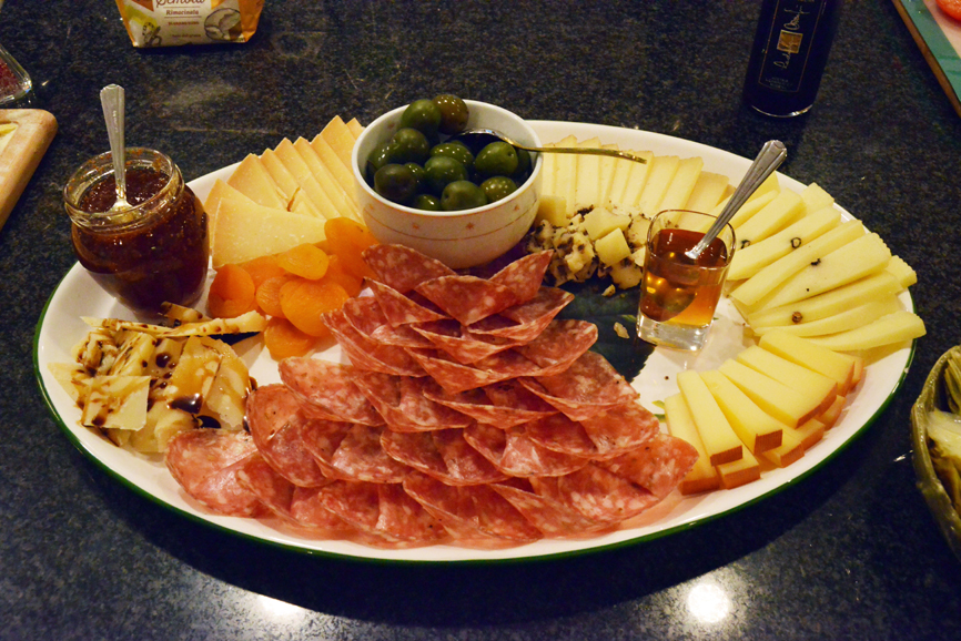 A platter of antipasti with salami, marinated green olives, a selection of selection of pecorino cheese and honey. Photograph by Bob Rozycki.