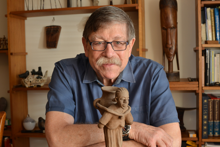 Dr. Richard 
Deckelbaum with one of his many Africa artifacts. Photograph by Bob Rozycki.