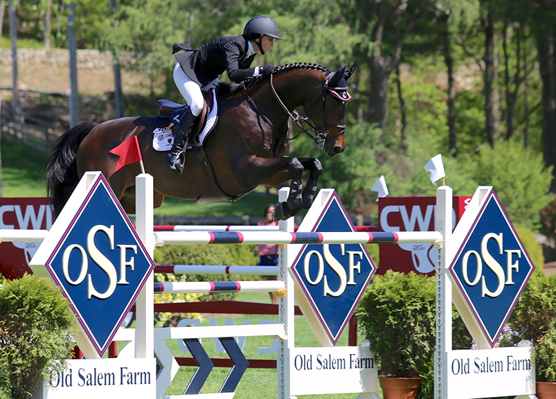 Georgina Bloomberg and Caleno 3 clear the signature Old Salem Farm fence while competing at the Spring Horse Shows. 