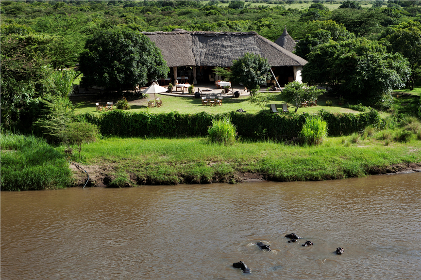The Karen Blixen Camp in Maasai Mara National Reserve is nestled in a bend in the river where dozens of hippos wade. 
