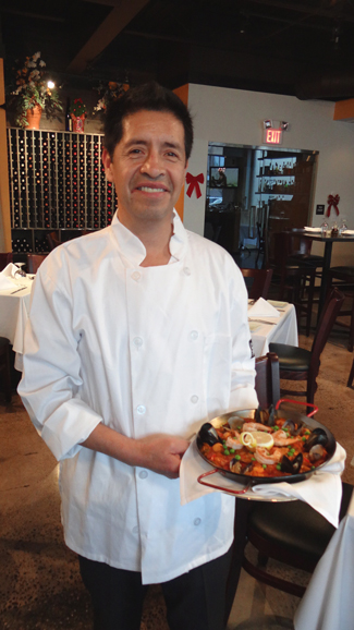 Daniel Lopez, owner and chef, with his signature paella. Photograph courtesy Taberna Restaurant Tapas & Wine Bar.