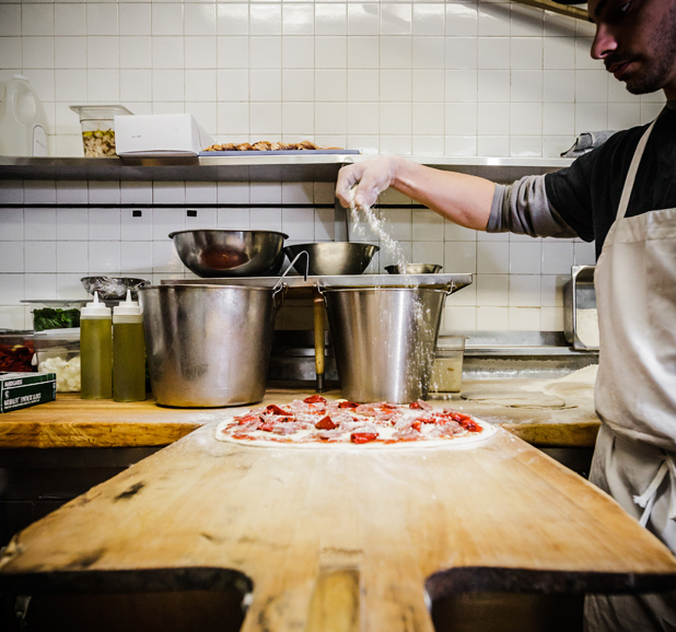 Toppings are added before the pizza enters the oven. Photograph courtesy Thomas McGovern Photography.