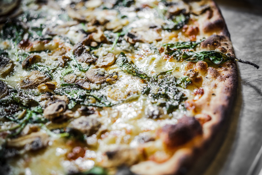 White pizza topped with spinach and mushrooms. Photograph courtesy Thomas McGovern Photography.