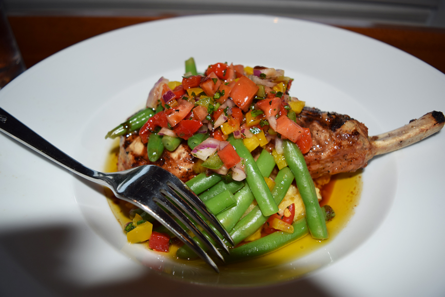 Salsa picante and green beans served atop a bone-in pork cutlet at Dere Street Restaurant. Photograph by Aleesia Forni.