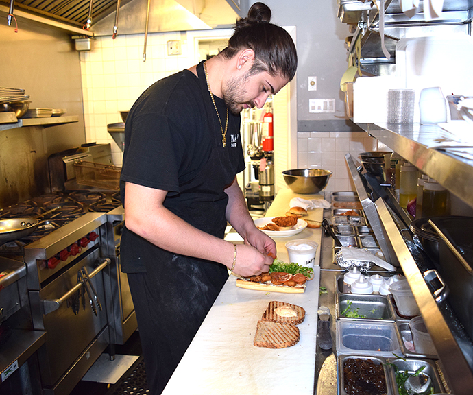 Chef and co-owner Louis Brindley prepares one of his craft sandwiches. Photograph by Aleesia Forni.