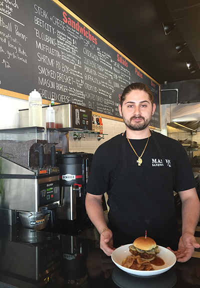 Chef and co-owner Louis Brindley presents one of his best-selling craft sandwiches, The Chickwich. Photograph by Aleesia Forni.