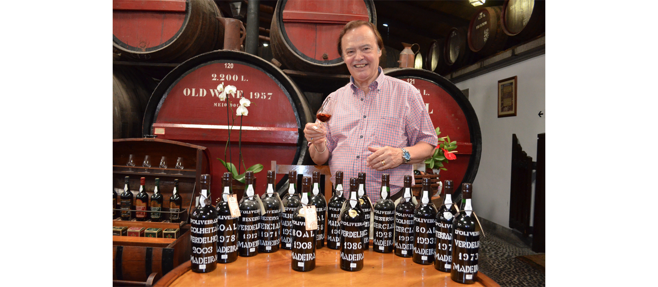 Luis D’Oliveira, executive director of Pereira D’Oliveira (Vinhos) Lda,, shown with a few of the exceptional vintages he shared with us. Photograph by Doug Paulding.