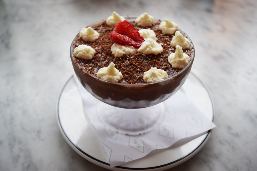 A Devil’s Food cake dessert topped with chocolate mousse, whipped cream and a fresh berry. Photograph by Aleesia Forni.