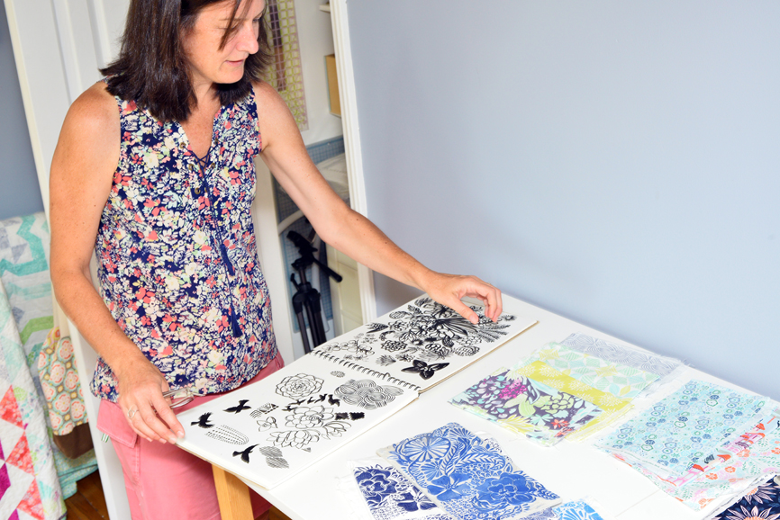 In her Bridgeport studio, Kate D. Spain shows how sketches are translated to fabrics. Photograph by Bob Rozycki. 