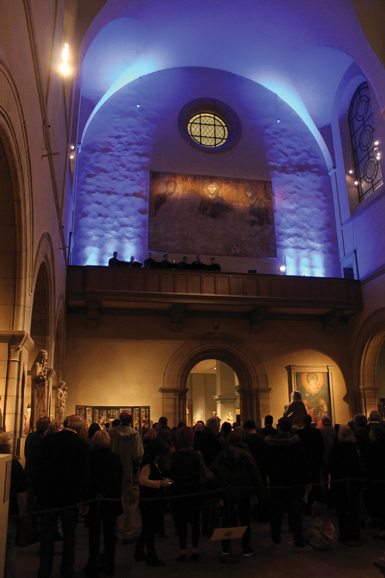 The Axion Estin Foundation's chanters performing in front of the only full-scale, authorized painted copy of the Deesis Mosaic from Hagia Sophia. Photograph by Christopher Alexander Fiore.