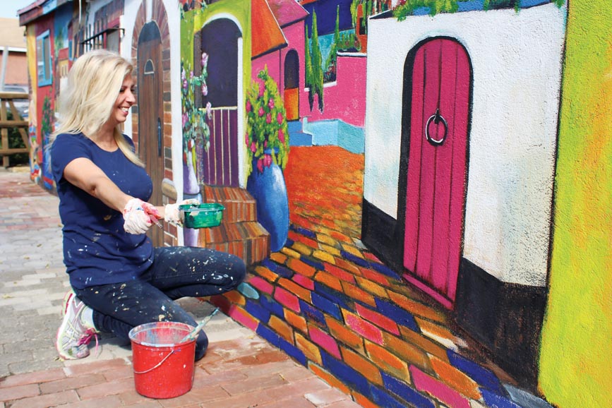 Suzanne Bellehumeur at work on her murals. Photograph by Bob Rozycki.