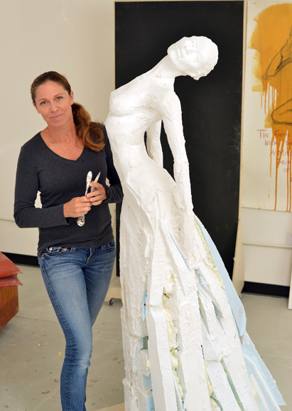 Paige adds clay to a sculpture. Photograph by Bob Rozycki. 